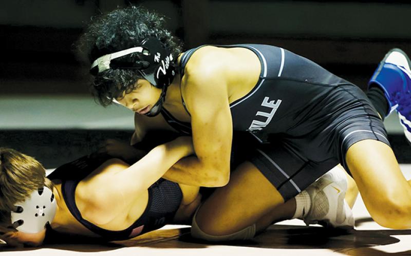Adair Panama hooks North Henderson’s Logan McMinn in a chicken wing during the annual “Fight for the Knight” Jan. 3. Panama ran up an 18-2 technical fall over  McMinn, giving Robbinsville five points in its 53-10 drubbing of the visitors. Photo courtesy of Miranda Buchanan/Robbinsville High School Yearbook