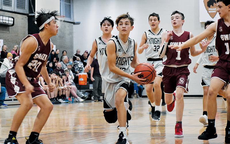 Robbinsville’s Eli Lambert (12) splits a pair of Maroon-Devil defenders during the Black Knights’ win over Swain County on Jan. 5. Photos by Kevin Hensley/sports@grahamstar.com