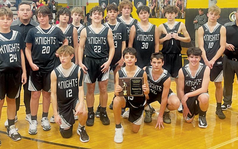 The Robbinsville Middle School Black Knights gathered on the court with their  runner-up plaque after the conference-tournament finale Jan. 19 at Murphy.