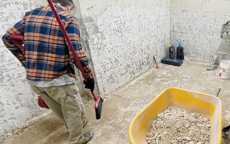 An unidentified worker looks over the floor of a bathroom that has been closed for remodeling at the Graham County Community Building. A pipe burst around the remodel overnight Friday, causing the county offices to close. As of Tuesday, the offices have not reopened. Photos by Randy Foster/news@grahamstar.com
