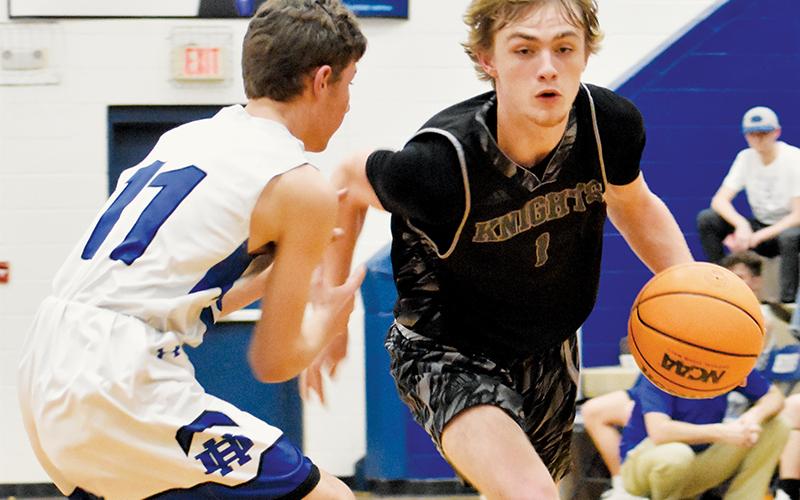 Senior Caleb Draper (1) slides past Hiwassee Dam’s Kyle Taylor during Monday’s road game. Photos by Kevin Hensley/sports@grahamstar.com