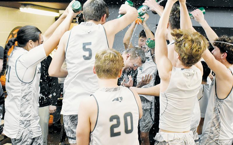 Members of the Black Knights mob head coach Jake Beasley in the locker room Tuesday, moments after Robbinsville wrapped up its first Smoky Mountain Conference title since the 2013-14 season. Photo by Kevin Hensley/sports@grahamstar.com