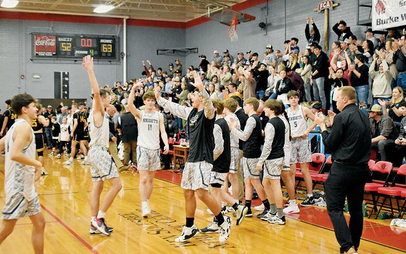 In junction with the players on the floor, the Black Knights’ passionate fanbase erupts inside the Ken Solesbee Athletic Center at the final buzzer Friday, as  Robbinsville wrapped up the 2022-23 Smoky Mountain Conference Tournament Championship by knocking off Murphy. Photo by Kevin Hensley/sports@grahamstar.com