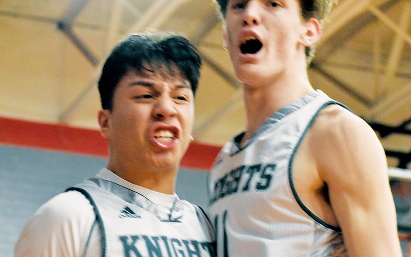 Robbinsville juniors Xander Wachacha (left) and Donovan Carpenter erupt in celebration after Wachacha drew the and-one after completing a transition basket Monday. Wachacha and Carpenter accounted for 30 of the Black Knights’ 47 points in the Smoky Mountain Conference semifinals against Hayesville. Photos by Kevin Hensley/sports@grahamstar.com