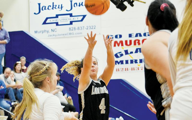 Desta Trammell unloads one of her 8 long-range shots Monday at Hiwassee Dam. In as many weeks,  Robbinsville’s senior point guard has twice broken the 40-point threshold. Photo by Kevin Hensley/sports@grahamstar.com