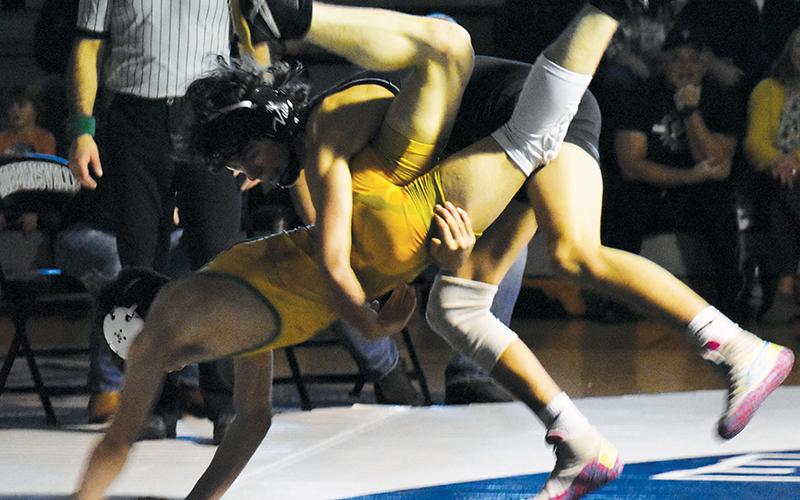 Christian Phillips drops Alleghany’s Eli Thomas during the second-round dual against the Trojans on Saturday. Phillips later won the 126-pound war in overtime, 9-7.