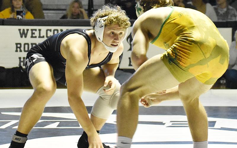 Black Knights senior Turner Jackson stares down Alleghany's Isaac Stokes at the outset of Jan. 28's, second-round state dual-team tournament match in Robbinsville. Photo by Kevin Hensley/sports@grahamstar.com