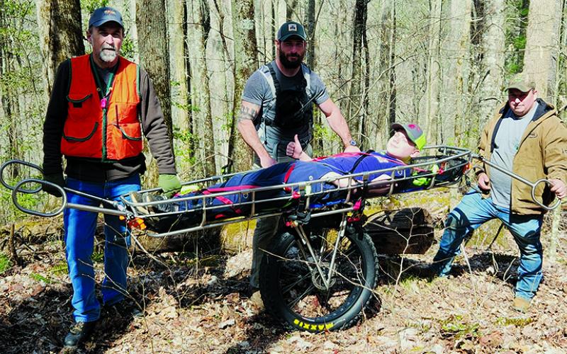 From left are Graham County Rescue Squad members Larry Crisp, Brent Eller and Zeb Hutchisen with “victim” David Grant on the stretcher during a Saturday training exercise on Stratton Bald Trail. Photo courtesy of Tory Lynnes/Graham County Rescue Squad