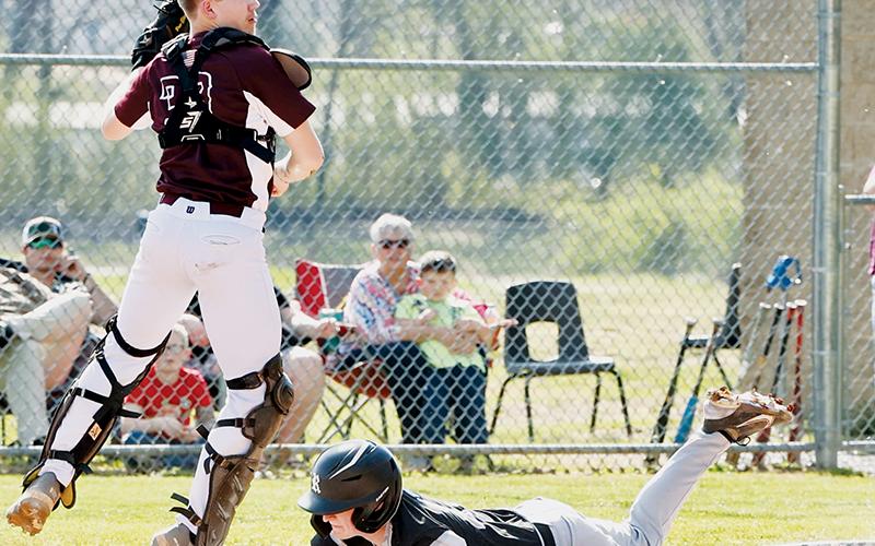 Thanks to an off-target relay, Black Knights senior Caleb Turpin slides safely into home Friday against Swain County. Photo courtesy of Miranda Buchanan/Robbinsville High School Yearbook