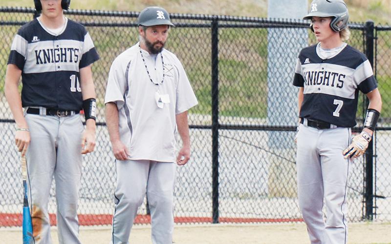 Lathan Buchanan, Robbinsville head coach Brent Icenhower and Alex Knight (from left) have a on-field discussion during a pitching change against Brevard on April 11. Buchanan and Knight are two of the seniors back for the varsity-baseball program this season. Photos courtesy of Crystal White/Robbinsville High School