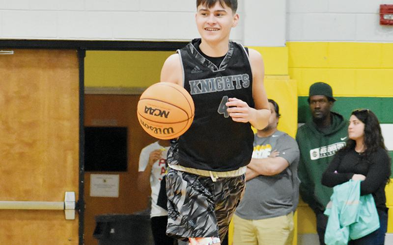 Bo Rattler cracks a smile as he brings the ball up the floor in the 1A West/Midwest All-Star Game on Saturday. Photo by Kevin Hensley/sports@grahamstar.com