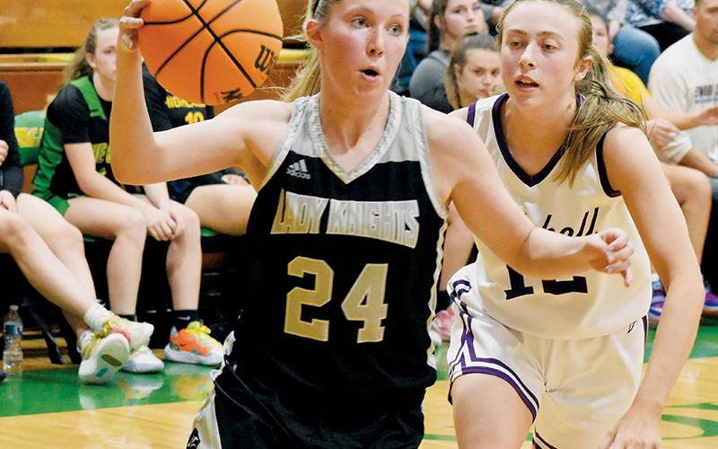 Kensley Phillips cuts past Mitchell's Mary Beth Woody during the second half of the 1A West/Midwest All-Star Game on Saturday. Photo by Kevin Hensley/sports@grahamstar.com