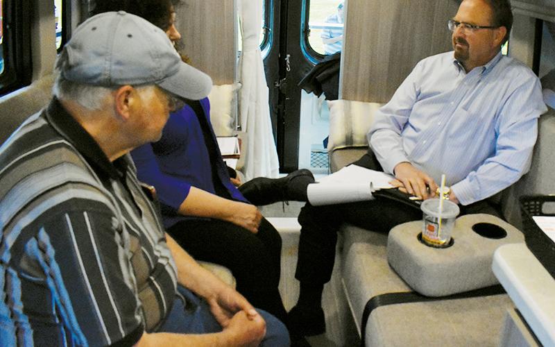 U.S. Rep. Chuck Edwards (right) meets with a pair of constituents during his “Carolina Cruiser” visit to Robbinsville on April 12. Photo by Kevin Hensley/editor@grahamstar.com