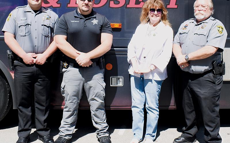 Dep. Chase Hughes, Chief Dep. Cody George and Lt. Jim Hyde (from left) represented the Graham County Sheriff’s Office at the June 13 “Border to Border” campaign launch at Deals Gap, which included the appearance of a mobile  sobriety-test unit, called a “Batmobile.” Between George and Hyde is Ellen Pitt, the Western chair for the Driving While Impaired Task Force.