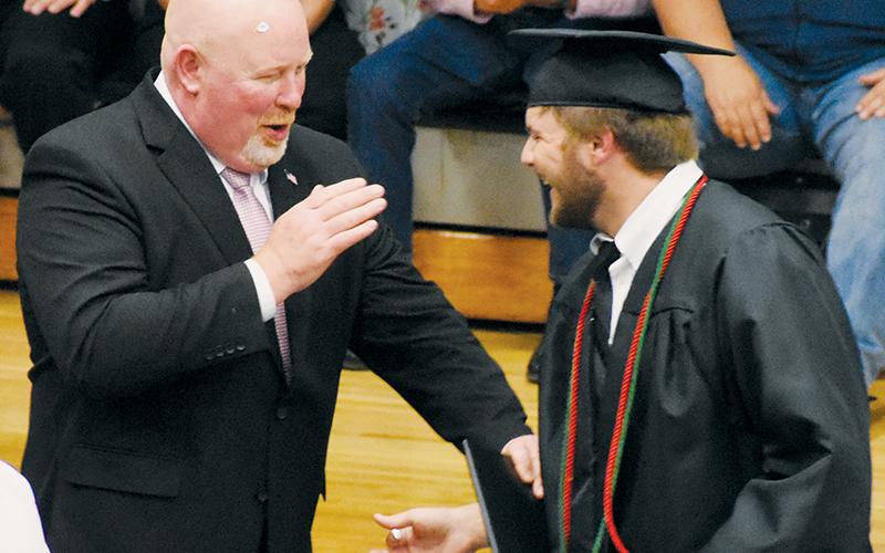Meanwhile, Judd Shuler opted to help the principal find a new hairstyle. No word was received by Wednesday’s press deadline about whether Shuler used Dapper Dan or Fop. Photo by Kevin Hensley/editor@grahamstar.com