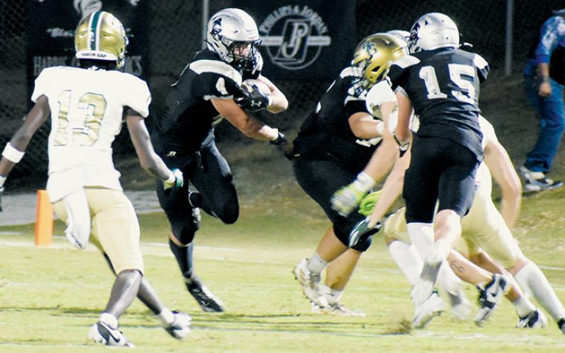 Senior running back Cuttler Adams pokes through an open spot during the second half of Friday’s home loss to Rabun Gap, Ga. Photos by Danielle Crabtree/The Graham Star