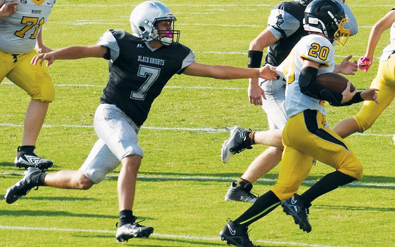 JV Black Knight Elijah Kirkland (7) attempts to slow down the efforts of Murphy’s Blake Davis on Sept. 7. Kirkland scored on the second play of Sept. 14’s road game at Andrews, which opened the floodgates in a 34-0 shutout of the Wildcats. Photo by Danielle Crabtree/The Graham Star