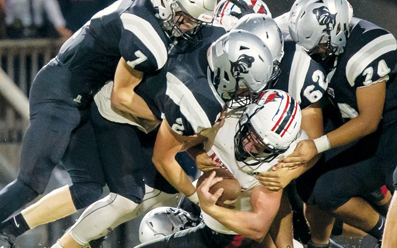 Members of the Black Knights’ defense – Blake Powers (7), Chase Calhoun (2),  Jonah Teesateskie (62) and John Dominguez (74) – crunch Andrews senior running back Dalton Rose during Friday’s homecoming win over the Wildcats. Photos courtesy of Maria Shook Photography