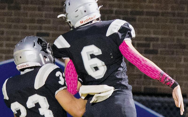 Bryce Adams (6) joins Kage Williams (33) in a celebratory moment after Williams caught a touchdown pass at the halftime buzzer Friday, which capped a 30-point first half for Robbinsville.