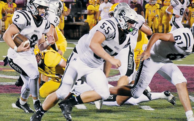 Chase Calhoun had his first 100-yard game in a Robbinsville uniform Friday, and he did it against his former school as part of a 46-6 rout at Cherokee. Running  interference for Calhoun are Koleson Dooley (55) and Isiac Collins (61). Photos by Kevin Hensley/sports@grahamstar.com