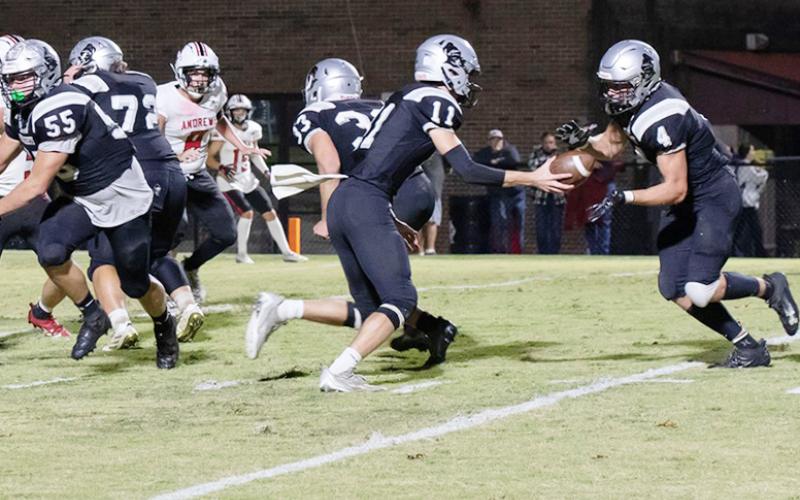 Robbinsville's Donovan Carpenter (11) delivers a handoff to Cuttler Adams during the waning moments of the first half Friday against Andrews. The Black Knights scalded the Wildcats 36-19 on homecoming. Photo courtesy of Maria Shook Photography