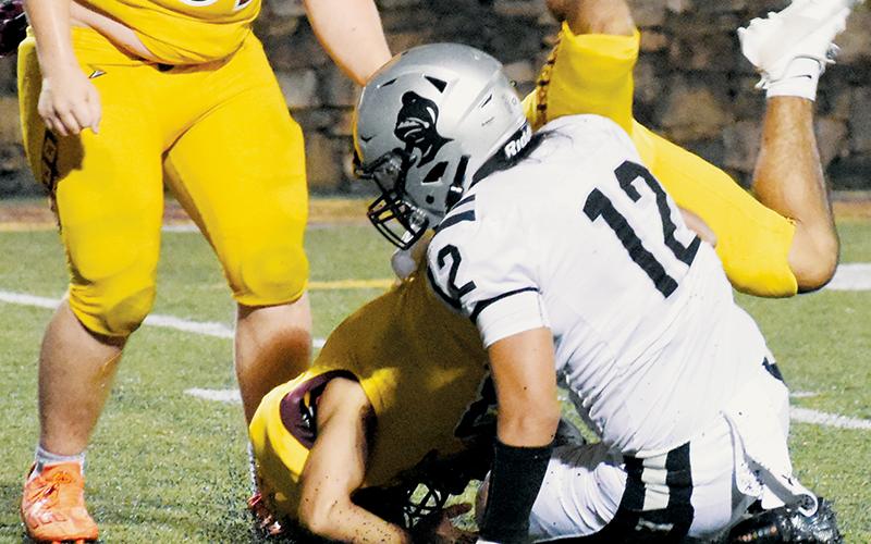 The Braves’ offensive line could not contain the pursuit of Quinn Jumper (12), who reached quarterback Michael Driver for this solo sack Friday. Jumper and Kage Williams later tag-teamed a drop of Driver for negative yardage.