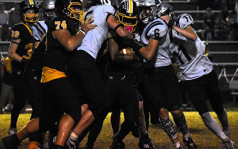 Roman Jones (15) and Bryce Adams (6) lead a sandwich of Murphy's Cameron Clem during the second half of Friday's 26-21 road victory over the Bulldogs. Photo by Kevin Hensley/sports@grahamstar.com