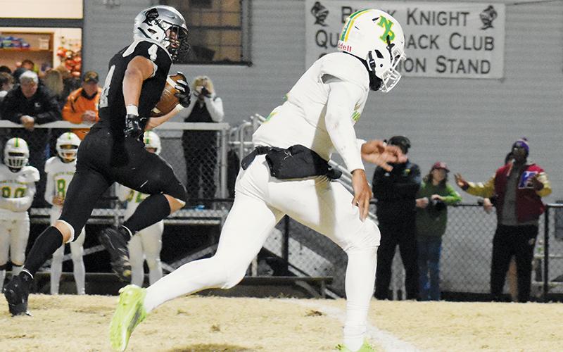 With nothing but open real estate in front of him, Robbinsville senior Cuttler Adams glances over at North Rowan’s Jarmais Morrow en route to a huge gain Friday against the Cavaliers. Adams set another rushing record in the game, while also tallying four touchdowns in the fourth round of the postseason. Photo courtesy of Faith Broome/Contributing Photographer