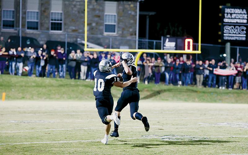 Knowing the outcome of the play was fully in the bag, Robbinsville senior Cuttler Adams reaches back for a high five from Tanner Hedden during his 102-yard interception return for the game-winning touchdown in the late stages of Friday’s win over Swain County. The victory solidified the Black Knights’ 27th divisional title. Photos by Miranda Buchanan/Robbinsville High School Yearbook