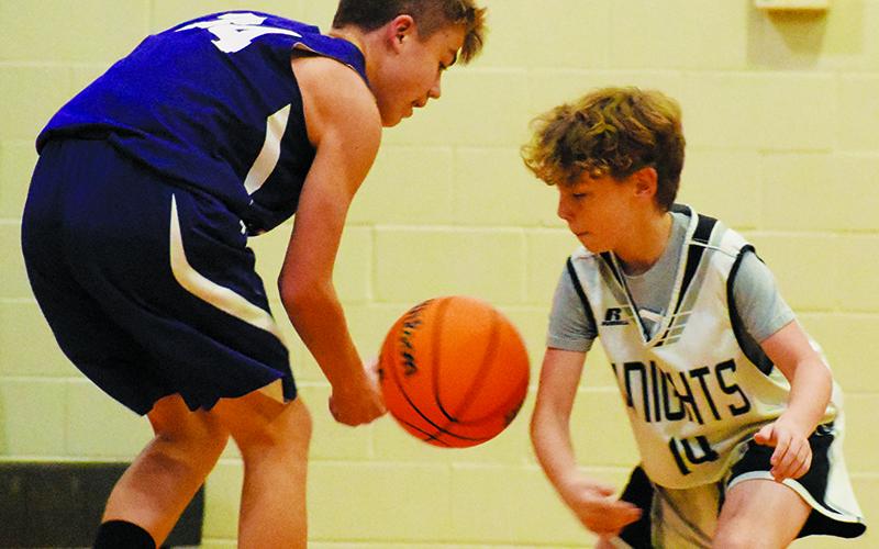 Tim Grant (14) swats the ball out of Camren Robinson's possession during Robbinsville's rout over Martins Creek on Nov. 20. Photo by Kevin Hensley/sports@grahamstar.com