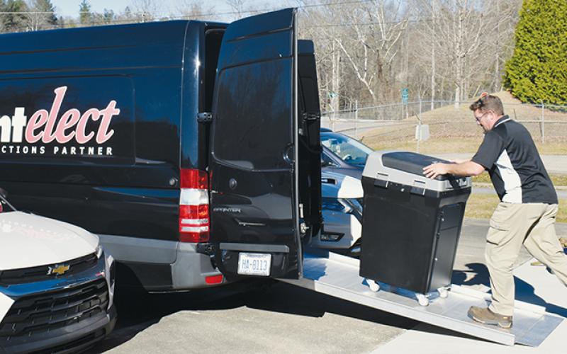 Service technician Chris Kingsbury loads up one of the 11 Print-Elect machines demonstrated in the Dec. 7 mock election. Photo by Ruby Annas/news@grahamstar.com