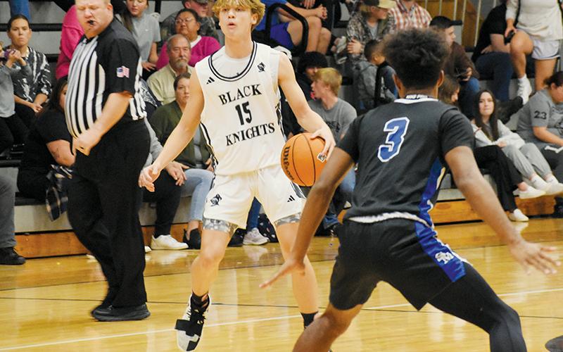 Dane Knott shouts instructions to the Black Knights in the ealry moments of Robbinsville’s win over Smoky Mountain on Dec. 7. A sophomore, Knott has taken the reins as the Knights’ point guard this season. Photos by Fala Welch/The Graham Star
