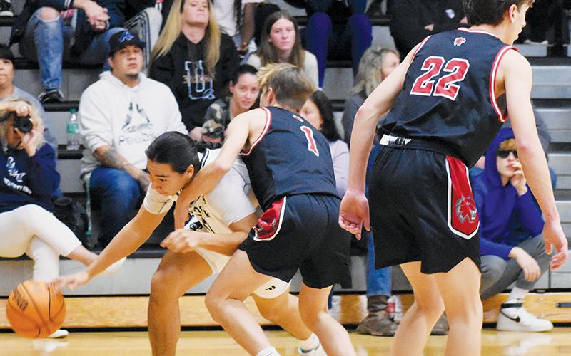 Robbinsville’s Quinn Jumper ducks around Andrews’ Gabe Clark during the Black Knights’ win over the Wildcats on Tuesday. Photo by Fala Welch/The Graham Star