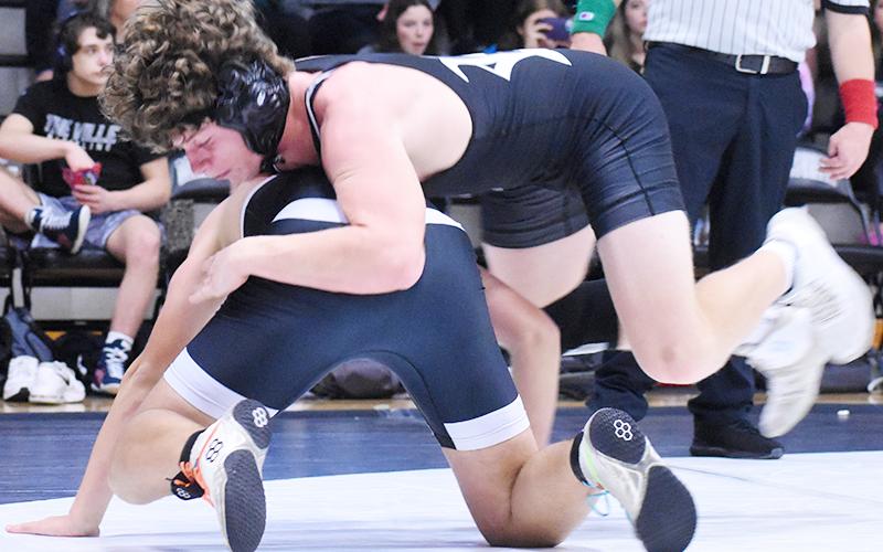Robbinsville's Christian Koeller leaps into position for top control during Saturday's first-round match against Mountain Island Charter. Photo by Kevin Hensley/sports@grahamstar.com