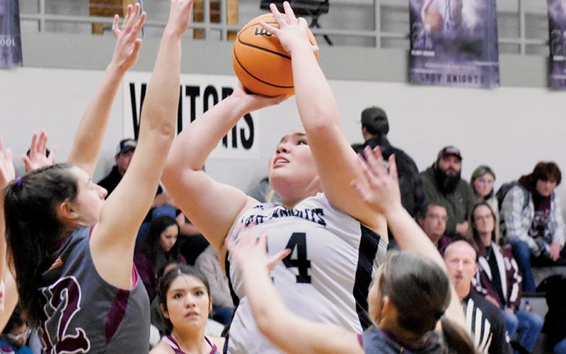 Senior power forward Aubrie Wachacha was not fazed by Swain County’s Carley Teesateskie (12) and  Molleigh Woodard (14) while putting up this inside shot Tuesday night. Photo by Fala Welch/The Graham Star