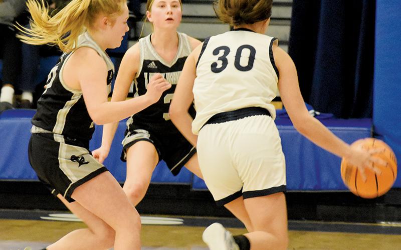 Robbinsville’s Novie Dutcher (left) and Abby Wehr close in for a corner trap on  Nantahala’s Zoey Passmore during the Lady Knights’ Jan. 11’s road win. Photos by Fala Welch/The Graham Star