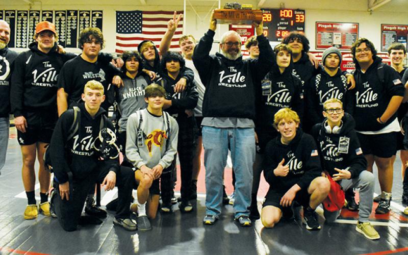 The Black Knights gather around the inaugural “Mill vs. The ‘Ville” trophy, which was brought back to Robbinsville on Dec. 28 in the wake of a huge dual victory at Pisgah. Photos by Kevin Hensley/sports@grahamstar.com