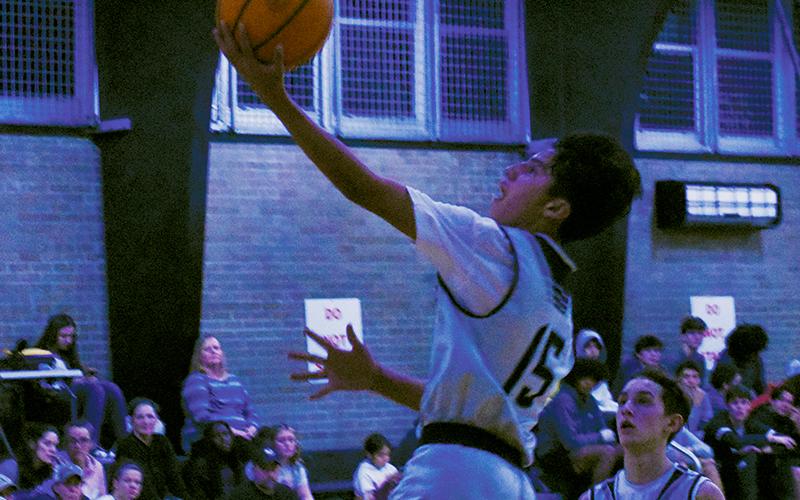 Amidst a first-quarter flurry, no one was at the basket to stop Xamuel Wachacha’s transition basket – and if they dared to interfere with the proceedings, Eli Lambert had a front-row seat to the bucket. Photo by Fala Welch/The Graham Star