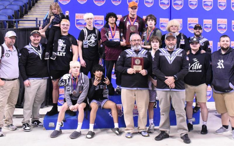 Members of "The 'Ville" bask in the moment of winning the program's inaugural state invitational tournament team title Saturday. Photo by Kevin Hensley/sports@grahamstar.com