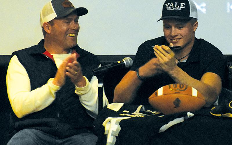 As his father Coy celebrates, Cuttler Adams speaks on the phone with Yale head coach Tony Reno, who helped Adams announce his college selection at a special Feb. 7 signing. Photos by Kevin Hensley/sports@grahamstar.com