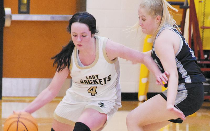 Sophomore guard Suri Watty (right) keeps a watchful eye on the outside antics of Hayesville’s Breanna Abrams during Tuesday’s loss in the semifinals of the conference tournament at Cherokee. Photos by Kevin Hensley/sports@grahamstar.com
