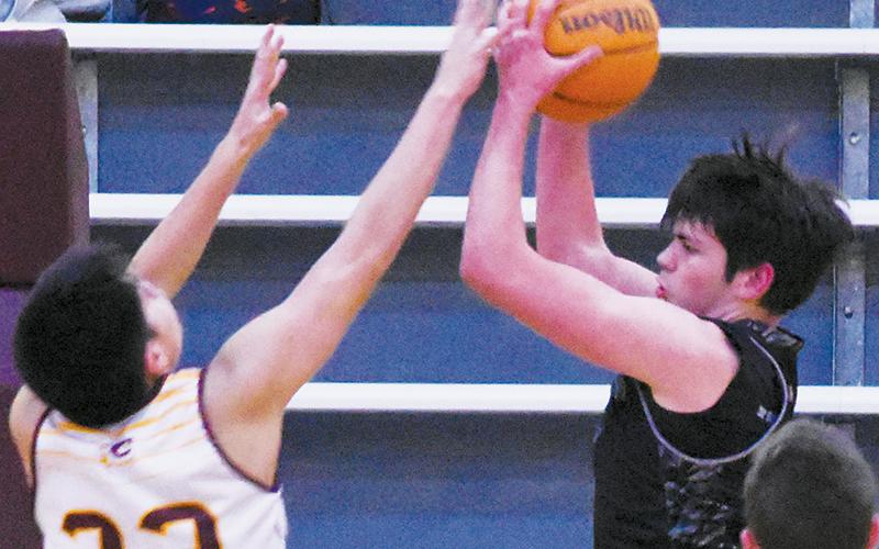 Isiac Collins pulls down a rebound during JV action at Cherokee on Feb. 13.