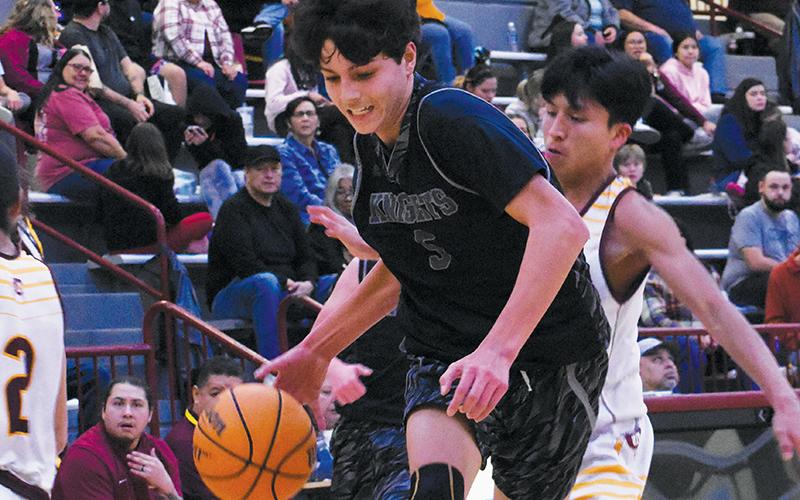 Tucker Jones leaps into the paint during Tuesday's JV boys clash in Cherokee.