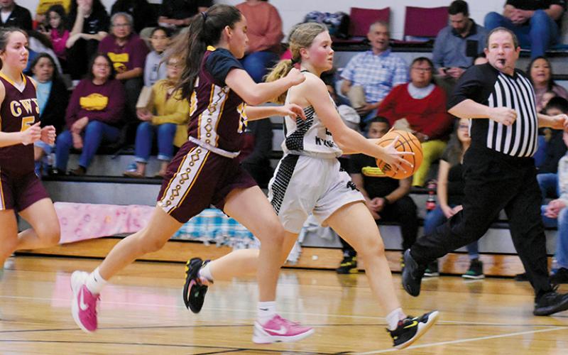 With Cherokee’s Brooklyn Panther in hot pursuit, MyKayla McGuire approaches the basket during the JV Lady Knights’ win on Friday.