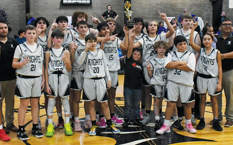 Capping off a 17-0 season, the Robbinsville Middle School Black Knights relish the moment after winning the Smoky Mountain Conference tournament Jan. 24. Photos by Fala Welch/The Graham Star
