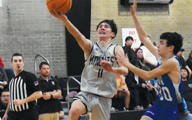 Bam Nelms flies past Hiwassee Dam/Ranger’s Dallas Roberson en route to a second-half basket during Jan. 24’s Smoky Mountain Conference Tournament finals. Nelms and eight other Black Knights are moving to the high school ranks next season.