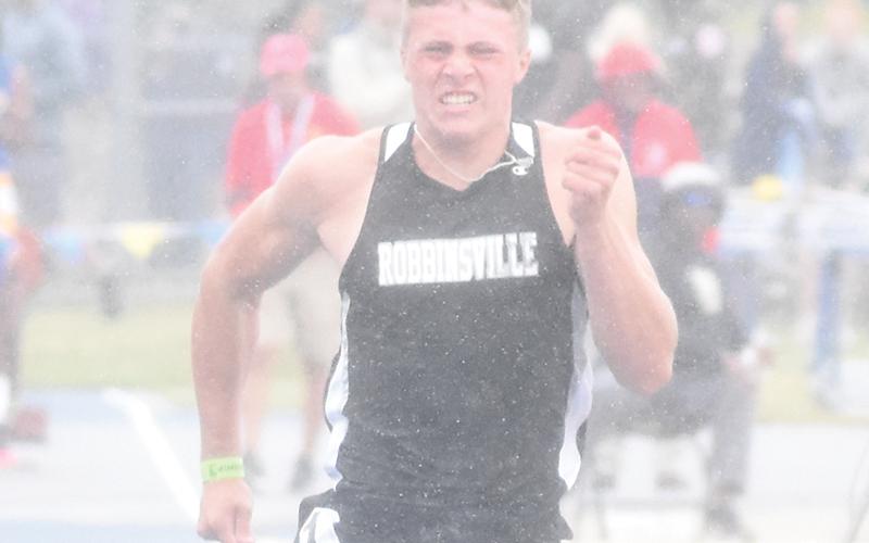 Robbinsville seniors Zoie Shuler and Cuttler Adams – shown competing at last year’s state championship meet – will help usher in the Knights’ 2024 track &amp; field season. As part of their curtain call, both are seeking returns to the 1A dance.