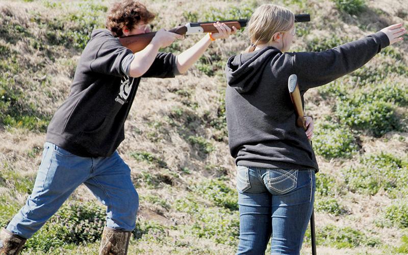 With his sister Bella looking on, Landen Eddings competes in the shotgun event at March 2’s FarWest Invitational. Photos courtesy of Cheri Lynn/Robbinsville Shooting Team