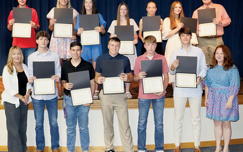 Twelve Robbinsville High School seniors were afforded scholarships totaling $52,000 on behalf of the Cody Family during the annual awards night May 21. All names are listed from left. Front row: Dana Cody Adams, Donovan Carpenter, Carter Burchfield, Cuttler Adams, Westin Nichols, Nathanael Shope and Amber Davis. Back row: Zeb Stewart, Karlee Stewart, Emma Beasley, Kalyn Cable, Aubree Nichols, Lindsay Batts and Aidan Holder. Photo courtesy of Crystal White/Robbinsville High School