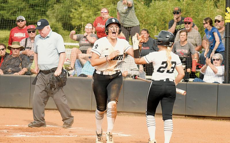 Members of the East Wilkes faithful pleaded their case, but Robbinsville junior Liz Carpenter was all fired up as she greeted Suri Watty after being called safe on a game-tying slide in Game 2 of the Western Regional Final Series on Friday. The deadlock was the closest the Lady Knights came to leading in the contest, as the Lady Cardinals went on to collect the victory and advance to the state finals. Photos by Jacquline Gayosso/The Graham Star